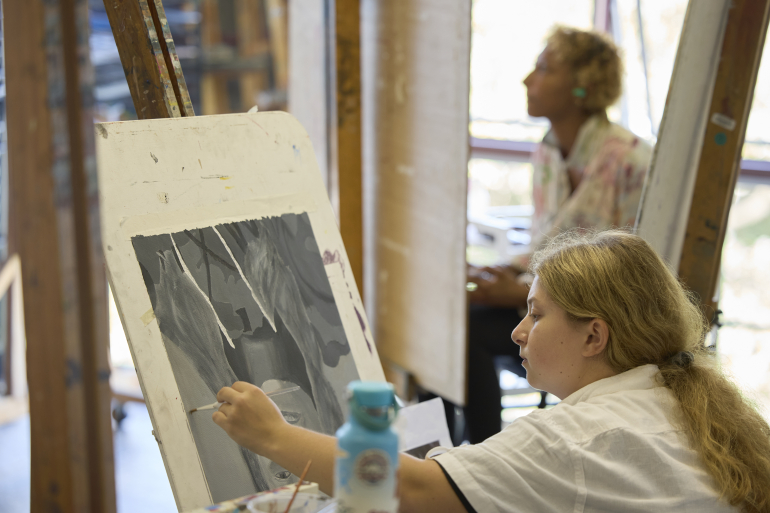 Students drawing on canvas in a Studio Art Practice class