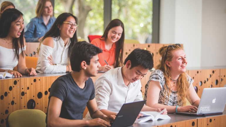 Image of students smiling and laughing in a classroom UNSW